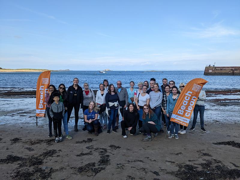 A large group of MCS Beach Clean volunteers pose together on North Berwick's West Beach on a sunny day